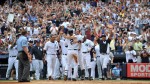 Derek Jeter celebrates with teammates after single home run 3000th hit./AP Photo